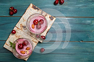 Summer yogurt dessert with sour cherry and jelly and decorated with fresh berries. banner menu recipe place for text, top view