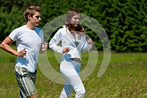 Summer - Young couple running in meadow