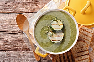 Summer Zucchini soup with thyme close-up in a saucepan. horizontal top view