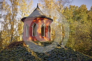 Summerhouse in autumn landscape