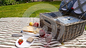 Summers day picnic set on the lawn with food and drink