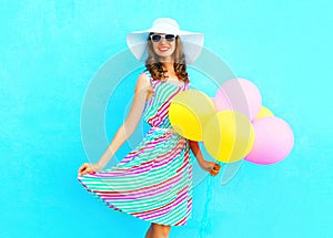 Summertime! Fashion happy smiling woman with an air colorful balloons