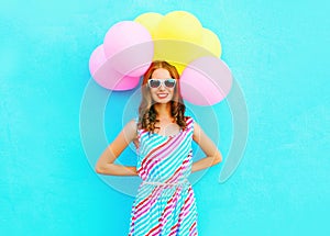 Summertime! happy smiling woman holds in hands an air colorful balloons