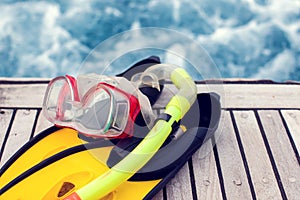 Summertime and holiday concept. Sea view. Diving mask and flippers lelft on boat