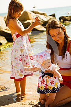 Woman playing with children on beach