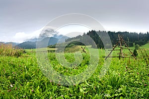 Summertime landscape with dirt road and view at covered with white clouds mount Velky Choc Great Choc in the Slovakia