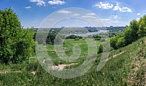 Summertime landscape panorama -river valley with hills