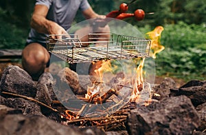 Summertime leisure concept image: man cooks a vegetabels on camp