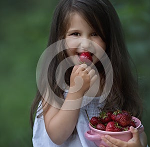 Summertime,  little girl eating strawberries