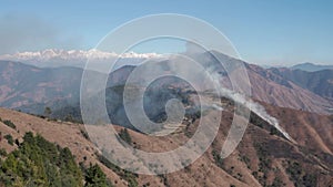 Summertime mountain wildfires engulf the Upper Himalayan terrain of Uttarakhand in the Tehri Garhwal region, India