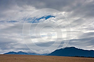 Summertime rural landscape against the background of mountains Western Carpathians