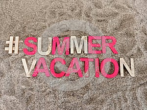 #summervacation summer vacation written on sand at the beach