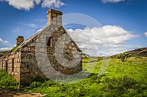 Summery old abandoned Glenfenzie farmhouse ruin in scotland