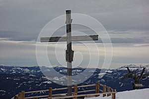 Summit cross as religious symbol on mountain top