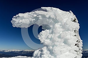 Summit landmark covered entirely in icy snow that forms a spectacular shape. Cabeza de Manzaneda Peak photo