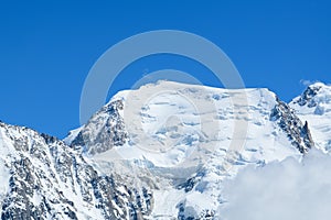 The summit of Mont Blanc du Tacul in the Mont Blanc Massif in Europe, France, the Alps, towards Chamonix, in summer on a sunny day