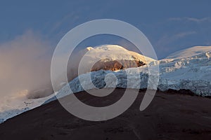 Summit and Yanasacha Rock wall in the Cotopaxi at dusk photo