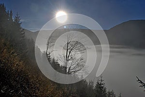 Sun above misty during morning in mountains