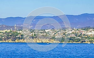 Sun beach cliffs rocks waves palms mountains Puerto Escondido Mexico