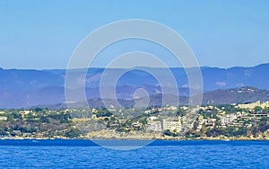 Sun beach cliffs rocks waves palms mountains Puerto Escondido Mexico