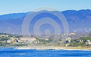 Sun beach cliffs rocks waves palms mountains Puerto Escondido Mexico