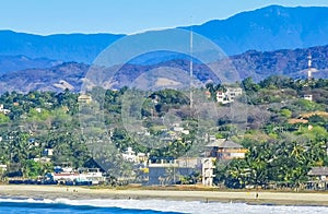 Sun beach cliffs rocks waves palms mountains Puerto Escondido Mexico