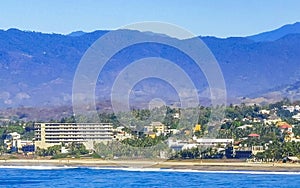 Sun beach cliffs rocks waves palms mountains Puerto Escondido Mexico