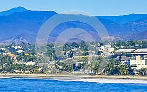 Sun beach cliffs rocks waves palms mountains Puerto Escondido Mexico