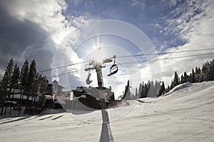 Sun beam behind the ski lift pole