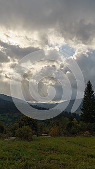 Sun beams from clouds on Carpathian mountains in Ukraine with copy space