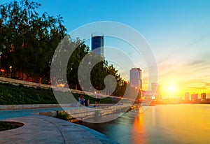 Sun and the beautiful sunset over the city center and city pond of Yekaterinburg in summer