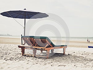 Sun bed with purple umbrella at the beach