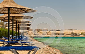 Sun beds along stone coastline