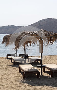 Sun beds and parasols on the beach at the beautiful Greek island of Ios.