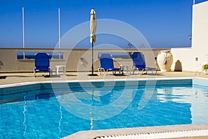 Sun beds and an umbrella by the pool in a hotel on the Mediterranean coast