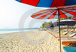 Sun beds and umbrella on a tropical beach