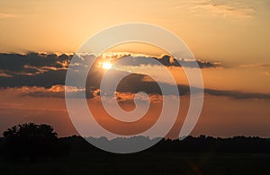 Sun behind clouds sunset , natural background