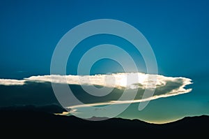 Sun behind clouds on sunset