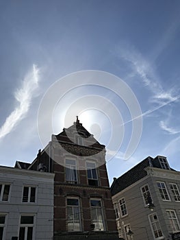 Sun behind an old house, during a summernight in Den Bosch, Netherlands