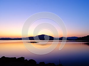 The Sun below the horizon, Twilight landscape of Rani Rashmi Devi Singh Reservoir, Chhattishgarh, India.