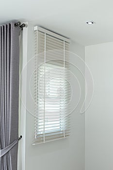 Sun-blocking blinds are hung on the windows