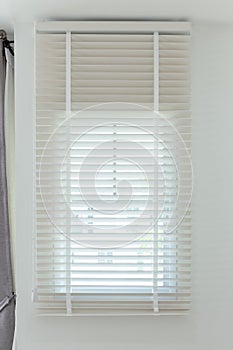 Sun-blocking blinds are hung on the windows