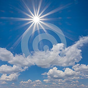 Sun on the blue cloudy sky background