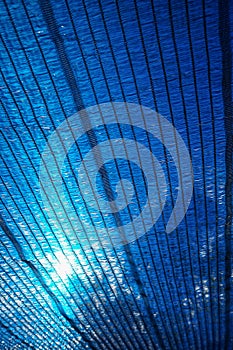 Sun Through a blue Shading net, plastic awning used as a sunshade