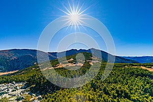 Sun on the blue sky over the mountains overlooking Musala in Rila Region, Bulgaria