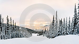 Sun breaking through the clouds on a Ski Hill