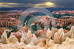 Sun breaks through dark clouds over Inspiration Point in Bryce Canyon National Park.