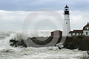 Sun Breaks Through Storm Clouds as Waves Crash By Maine Lighthouse