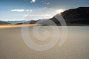 Sun Burst Over The Peaks Above The Dry Lake Bed of Racetrack Playa