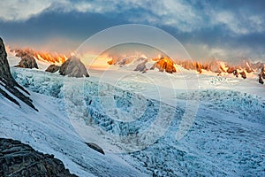 The sun bursting through the thick cloud at the top of the glacier